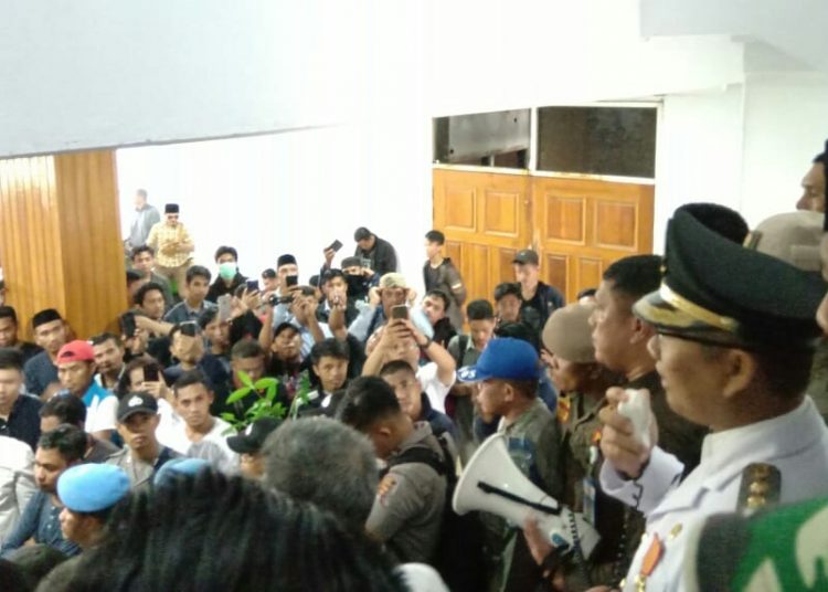 Wali Kota Kendari, Sulkarnain Kadir (baju putih, pegang megafone) sedang menyampaikan penjelasan kepada deminstran. Foto: Dok. TNC